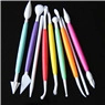 Flat lay of 8 double-headed fondant carving tools with various tips on black background