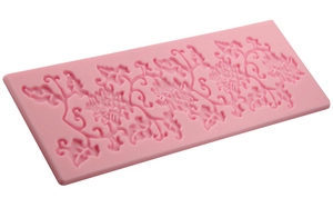 Macro detail of pink floral lace silicone fondant mold showing intricate carvings