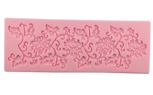 Detailed macro view of pink silicone lace mold featuring intricate floral vine textures