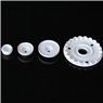 Detail view of four white plunger cutters in varying sizes for snowflake cake decorating