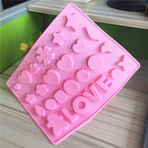 Pink silicone baking mold with heart star shapes and LOVE lettering for chocolate and ice