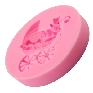 Pink silicone mold for fondant cakes featuring a detailed baby carriage design