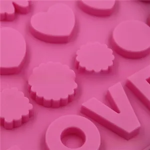 Detailed close-up of pink silicone mold featuring heart shapes and LOVE letter cavities