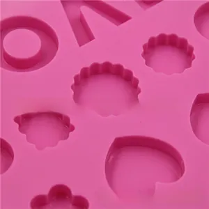 Close-up of pink silicone mold with heart and flower shapes for DIY chocolate baking