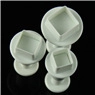 Three white plum blossom plunger cutters for fondant and cookie dough on black background