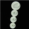 Detailed view of four circular white plunger molds for cake decorating and fondant embossing