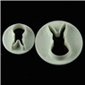 Detailed view of two white rabbit-shaped cookie cutters for fondant and DIY baking