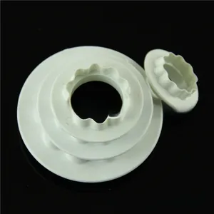 Detail of white plastic double-sided ruffled cake cutters for DIY fondant and baking