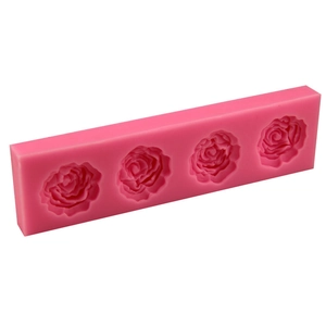 Pink silicone fondant mold with four medium rose flower shapes for cake decorating