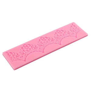 Pink rectangular silicone lace mold with intricate floral and mesh textures for cake fondant