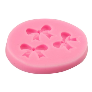 Pink silicone fondant mold featuring three different bow designs for cake decorating