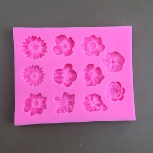 Pink silicone mold featuring 11 varied flower shapes for fondant cake decorating and DIY baking