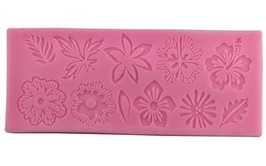 Pink silicone fondant mold featuring assorted floral and leaf patterns for DIY cake baking