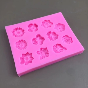 Pink silicone rectangular fondant mold with 11 different floral cavities for cake baking
