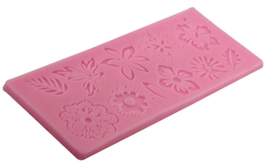 Pink silicone fondant cake mold featuring various floral and leaf patterns for DIY baking