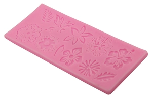 Pink silicone fondant mold featuring detailed floral and leaf patterns for cake decorating