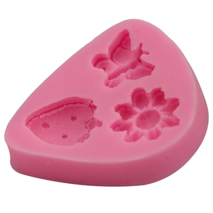 Pink silicone mold featuring butterfly, flower, and strawberry shapes for DIY baking