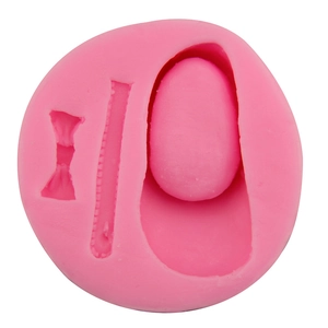 Pink silicone fondant mold featuring bow and zipper designs for DIY cake decoration