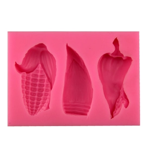 Pink silicone vegetable molds for fondant cakes and chocolate featuring corn and pepper shapes