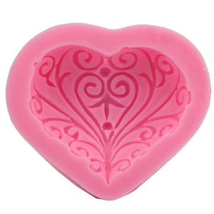 Pink heart silicone cake mold featuring intricate scrollwork relief for DIY baking tools