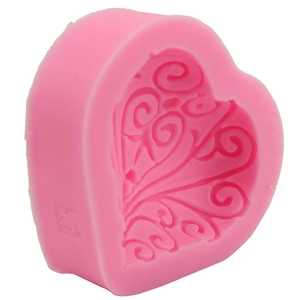 Pink heart-shaped silicone mold with intricate floral relief for DIY cake decorating