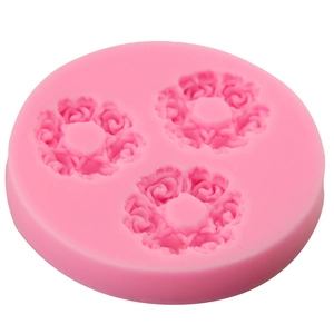 Pink silicone mold featuring three rose flower cavities for fondant cake decorating