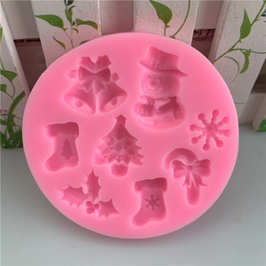 Pink silicone Christmas mold featuring bells, snowmen, snowflakes and tree shapes