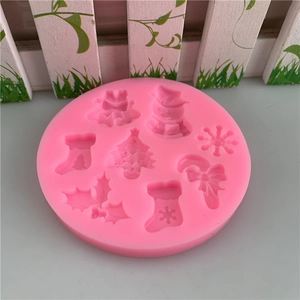 Pink silicone mold for Christmas fondant cakes featuring snowman and tree patterns