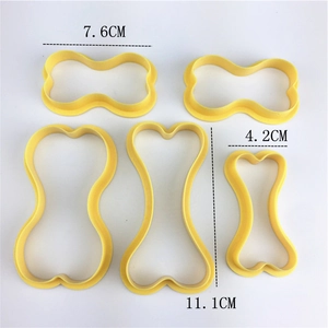 Set of 5 bone shaped yellow plastic cookie cutters in various sizes for DIY baking
