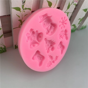 Pink Christmas silicone mold featuring snowman, bell, tree, and snowflake patterns