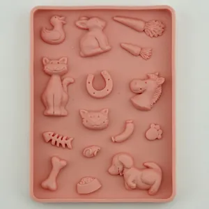 Pink silicone fondant mold featuring cute animal shapes like ducks, bunnies, and cats