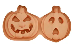 Detail of orange silicone pumpkin mold with two different carved face designs for DIY