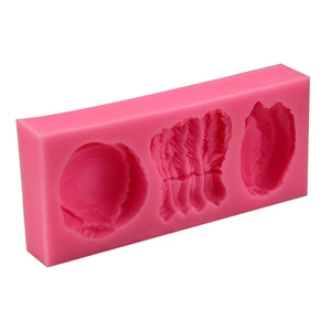 Pink flexible silicone mold with three leaf feather shapes for fondant and chocolate baking