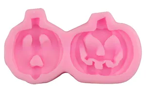 Close-up of pink silicone baking mold with two Jack-o'-lantern pumpkin shapes for fondant