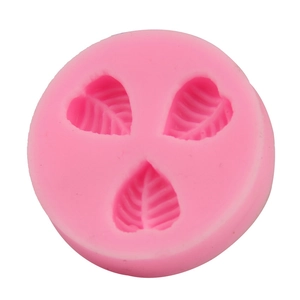 Detailed macro view of pink silicone leaf mold with three detailed leaf vein cavities