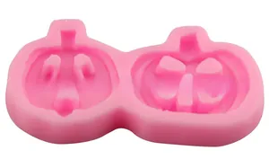Detail of pink silicone pumpkin lantern molds with smiling face patterns for DIY baking
