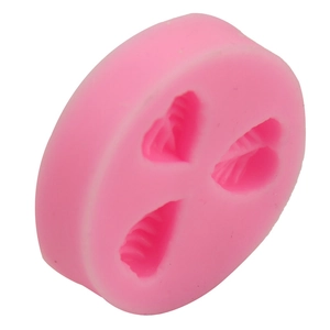 Macro detail of the round pink silicone mold featuring three leaf-shaped creative cavities