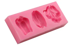 Pink silicone fondant mold featuring three detailed feather and wing shapes for baking