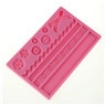 Detailed pink silicone fondant mold featuring bow, buttons and flower patterns for cake
