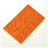 Detail of orange silicone mold with embossed flower and wave patterns for cake decorating