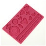 Macro detail of pink silicone cake lace mold with floral and heart patterns for fondant icing