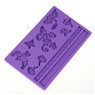 Detail of purple silicone fondant mold with butterfly, flower, and leaf embossments