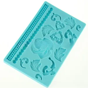 Detail of light blue silicone mold with rose flower, heart and bead chain patterns