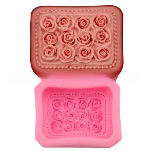 Detail view of 12-cavity rose silicone mold showing flexible pink texture and floral shapes