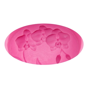 Macro detail of orchid flower patterns inside a pink silicone fondant and soap mold