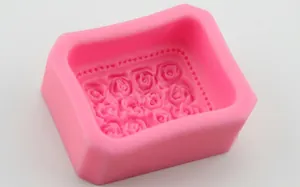 Pink silicone mold for 12 rose-shaped cakes and soaps with detailed floral patterns