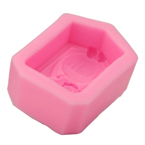 Macro detail of a pink silicone mold showing the cartoon girl shape for DIY baking crafts