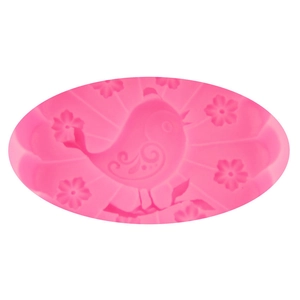 Macro detail of pink silicone mold with peacock and cherry blossom relief pattern
