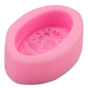 Pink oval silicone mold with embossed flower pattern for DIY soap and candle making