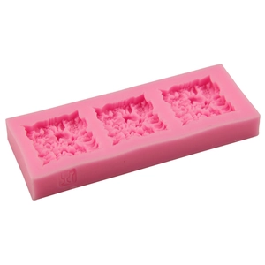 Pink 3-cavity rectangular silicone mold with intricate floral lace patterns for baking